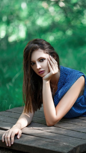 Model in blue dress on wooden platform
