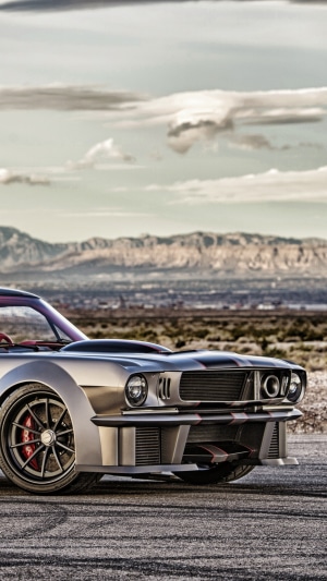 Custom Ford Mustang with racing stripes in a desert landscape