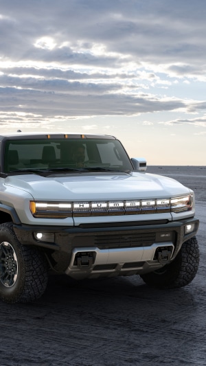 GMC Hummer EV truck on a sandy terrain
