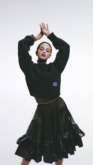 Selena Gomez in black sweater and skirt