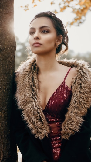 Model in sequined dress and fur coat