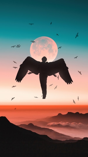 Silhouette of an angel with wings against a large moon