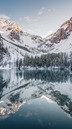 Snowy mountains reflected in a calm lake