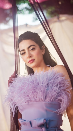 Emeraude Toubia in a light purple dress