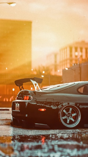 Black Toyota Supra with Spoiler on Wet Street