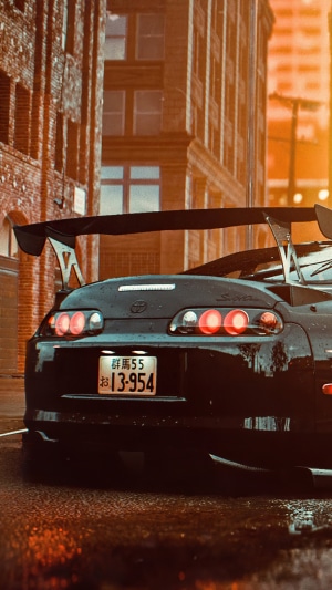 Black Toyota Supra with Spoiler in City at Sunset