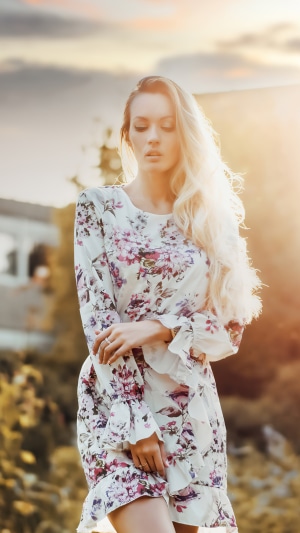 Woman in floral dress in golden hour light