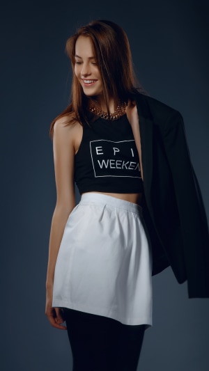 Model wearing crop top and white skirt