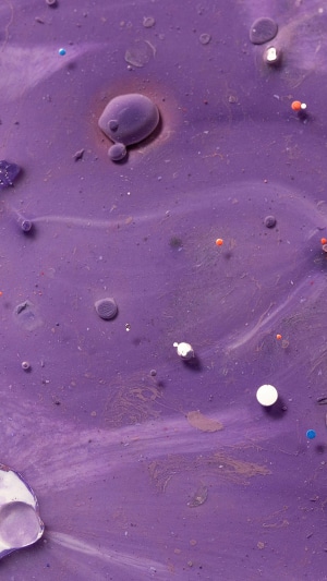 Abstract purple fluid with colorful droplets