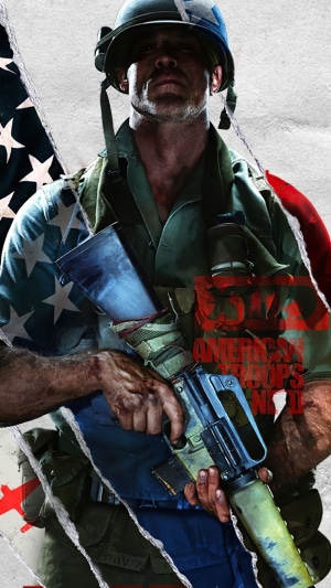 Soldier in American flag shirt holding rifle