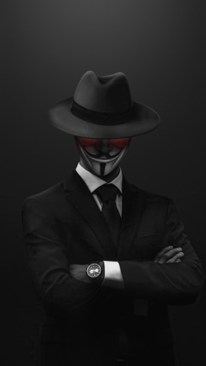Anonymous figure in a suit and hat with red eyes