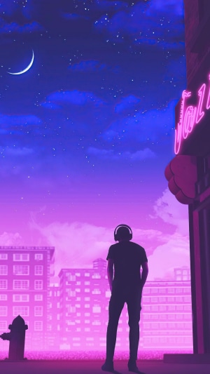 Man with headphones in a neon city at night