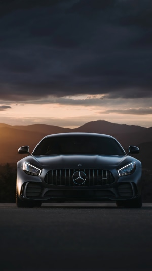 Mercedes-Benz AMG GT parked at sunset with mountains