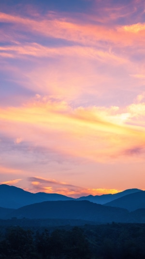 Sunset over mountains with colorful clouds