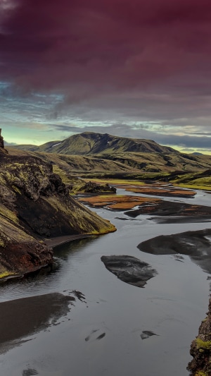 Mountains and river under a dramatic sky