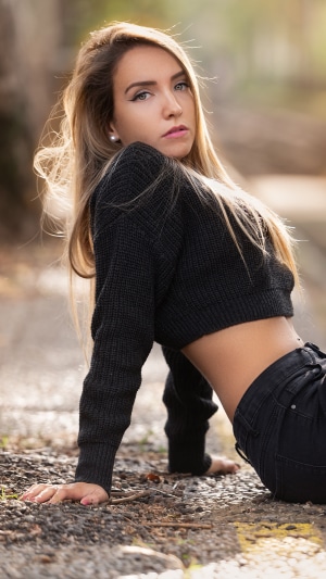 Woman in black sweater and jeans outdoors