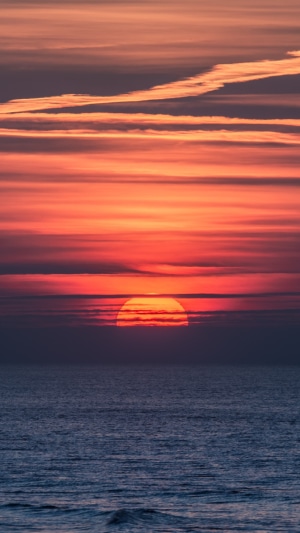 Sunset over the ocean with clouds