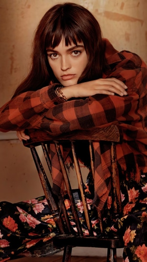 Emma Mackey in plaid shirt and floral pants