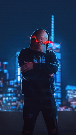 Man in mask with glowing eyes in front of city skyline
