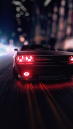 Dodge Challenger with red headlights driving at night