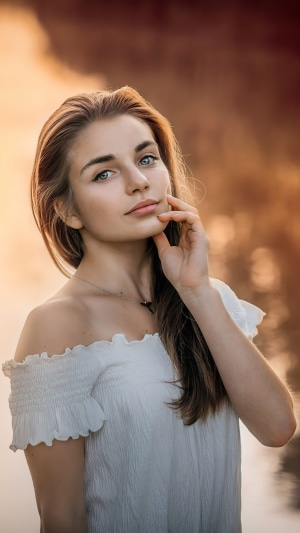 Young woman with blue eyes and white off-the-shoulder top