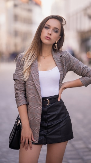 Woman in plaid blazer and leather skirt