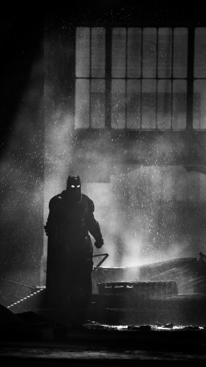 Batman in a dark industrial setting