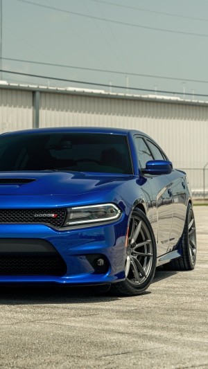 Blue Dodge Charger parked on concrete