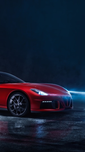Red sports car with headlights on