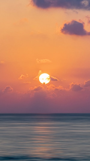 Sunset over the ocean with clouds