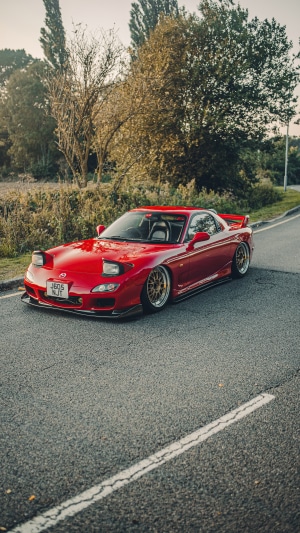 Red Mazda RX-7 parked on a road