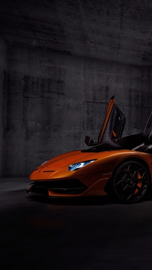 Orange Lamborghini Aventador SVJ with doors open