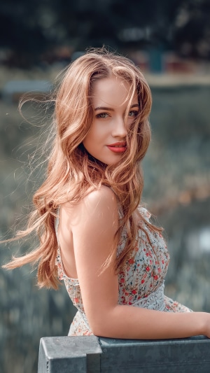 Woman with long wavy hair in a floral dress