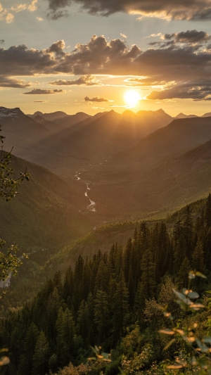 Sunset over mountains and forest valley