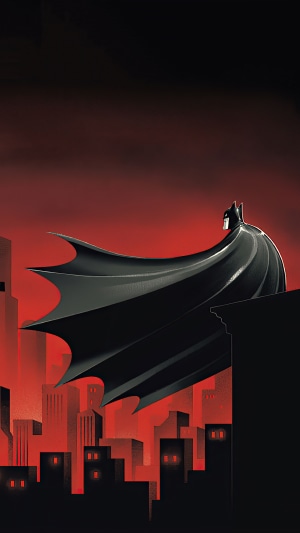 Batman overlooking a city at night