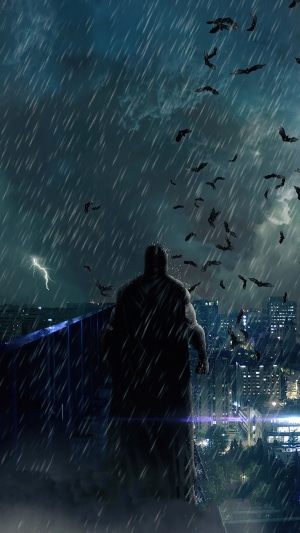 Batman in the rain with bats and lightning