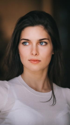 Model with blue eyes in white shirt 4K