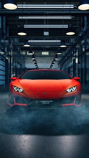 Red Lamborghini Huracan in a garage with smoke