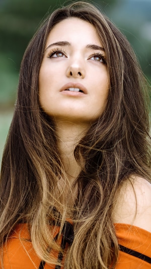 Model in orange dress looking up