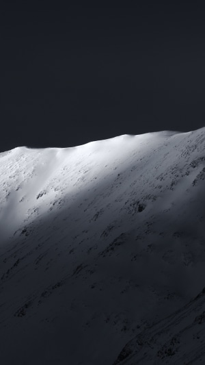 Snowy mountain ridge in dramatic light 4K