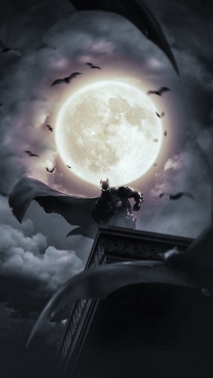 Batman on a rooftop with a full moon and bats