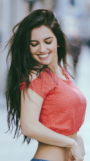 Model smiling in a red top