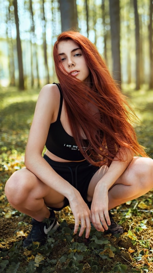 Redhead model posing in a forest, 4K