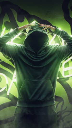 Anonymous person in a hoodie with green neon artwork