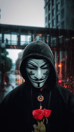 Anonymous figure in a hoodie holding roses