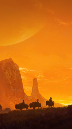 Cowboys riding bisons in a desert landscape