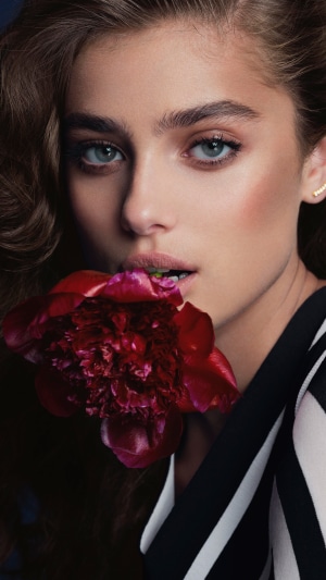 Taylor Hill with a red flower