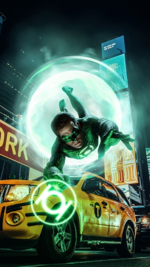 Green Lantern flying over a yellow taxi in Times Square