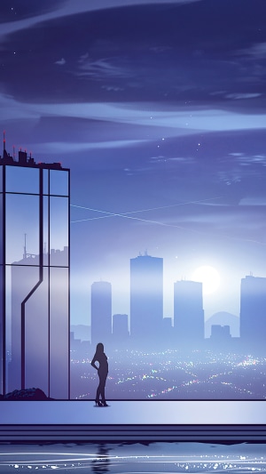 Woman overlooking a city skyline at night