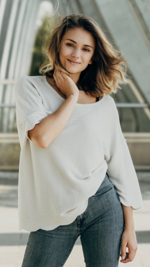 Woman in white sweater and jeans